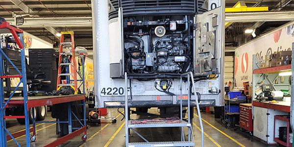  Safeway Carrs freight truck parked in a mechanics garage.