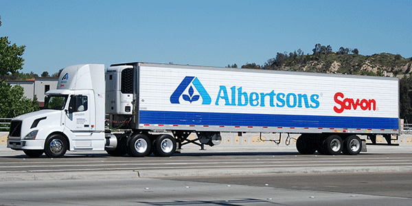 Albertsons freight truck in gas station.